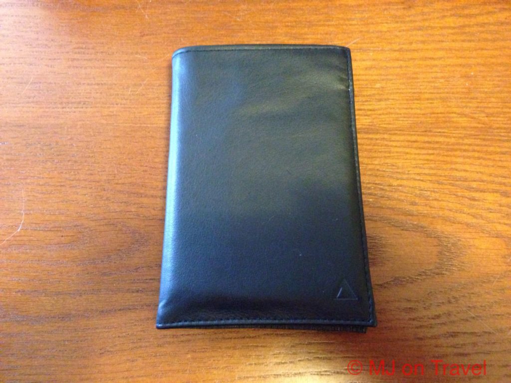 a black leather wallet on a wood surface