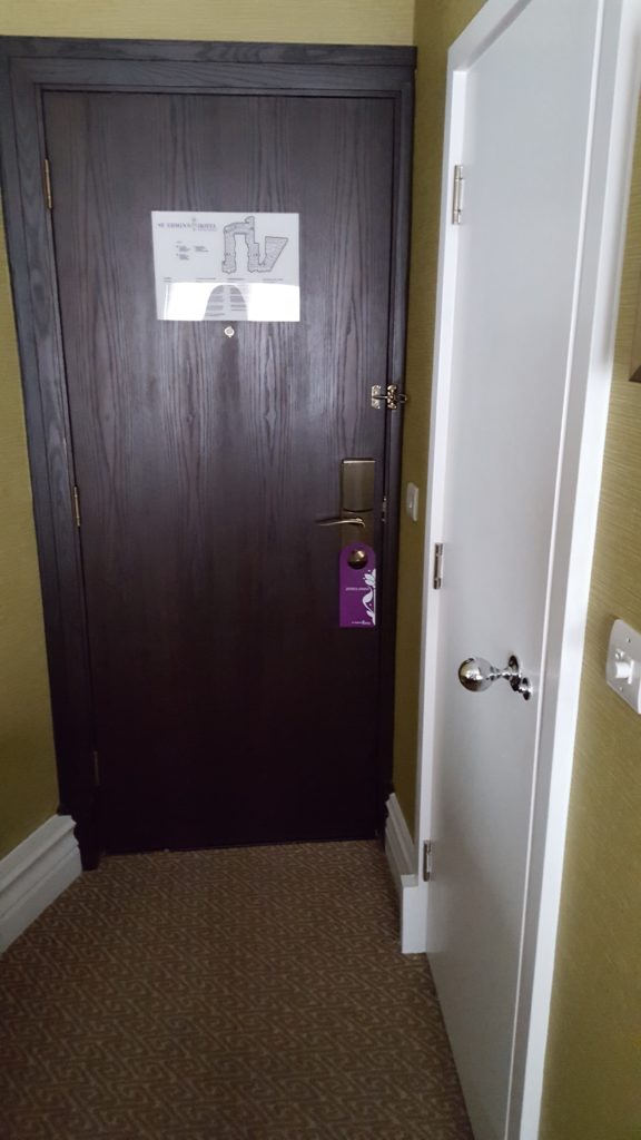 The door to the room and the bathroom on the right