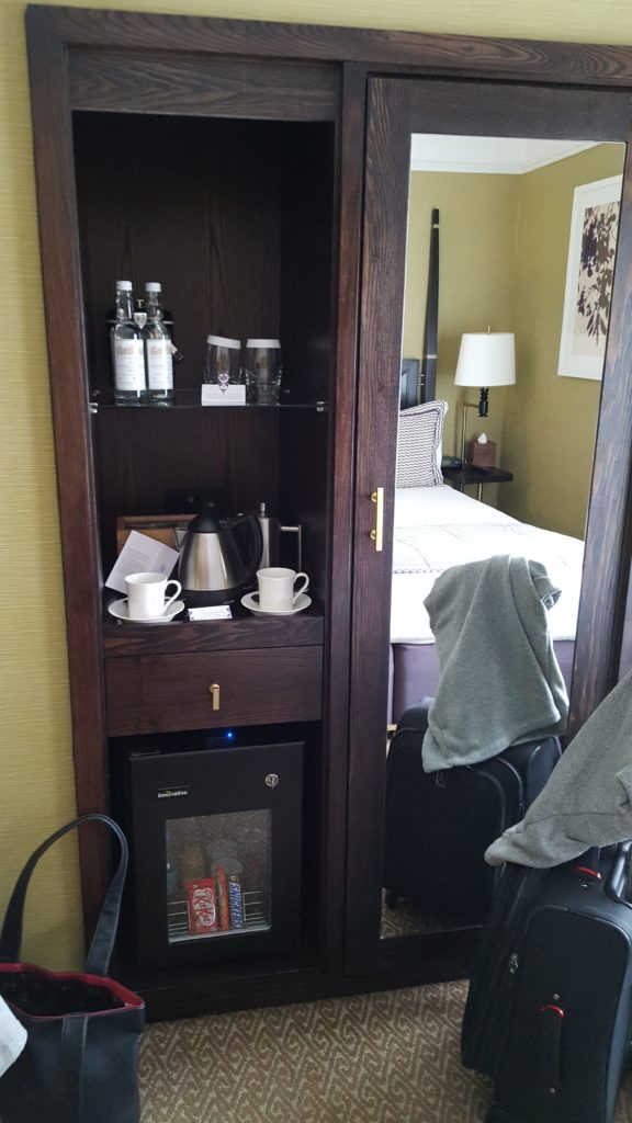 The mini bar sections with a closet next to it.