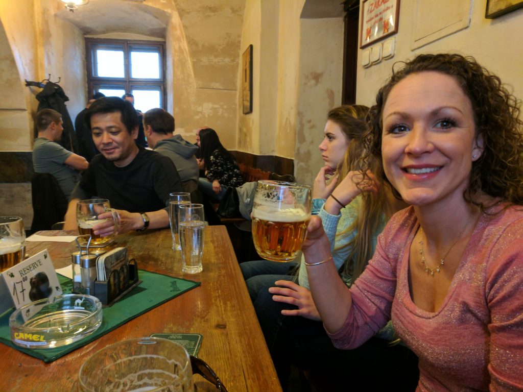 a woman holding a glass of beer