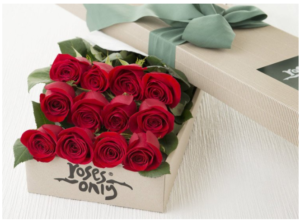 a box of roses with a green ribbon