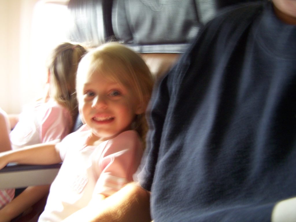 a child smiling in a car